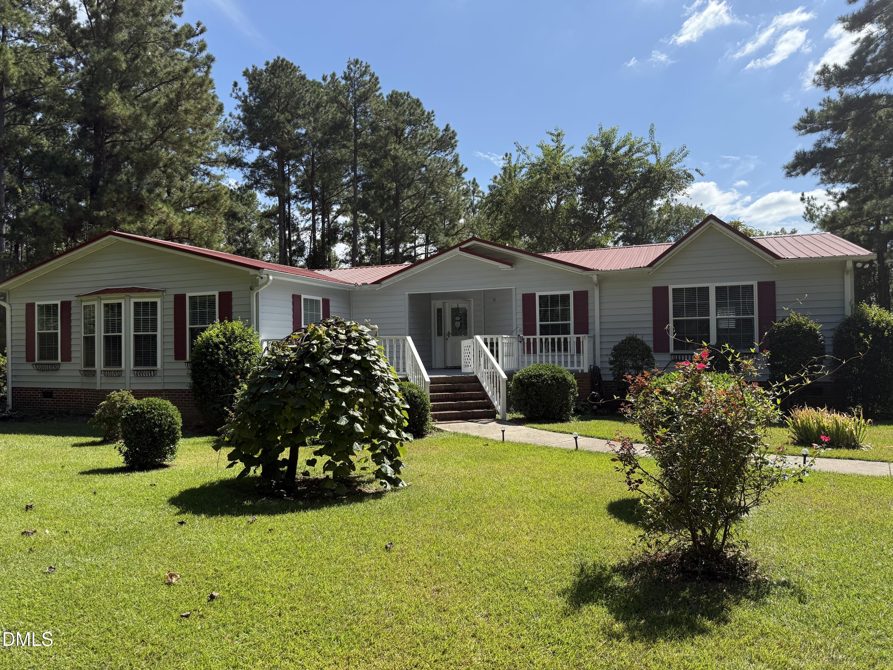 598 Ridge View Drive Cameron, NC 28326 - Photo 1 of 22 a front view of a house with a yard table and chairs