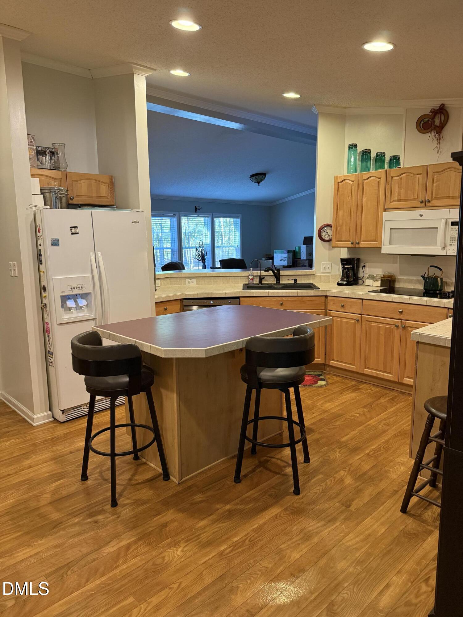 598 Ridge View Drive Cameron, NC 28326 - Photo 11 of 22 a kitchen with stainless steel appliances kitchen island granite countertop dining table chairs sink and cabinets