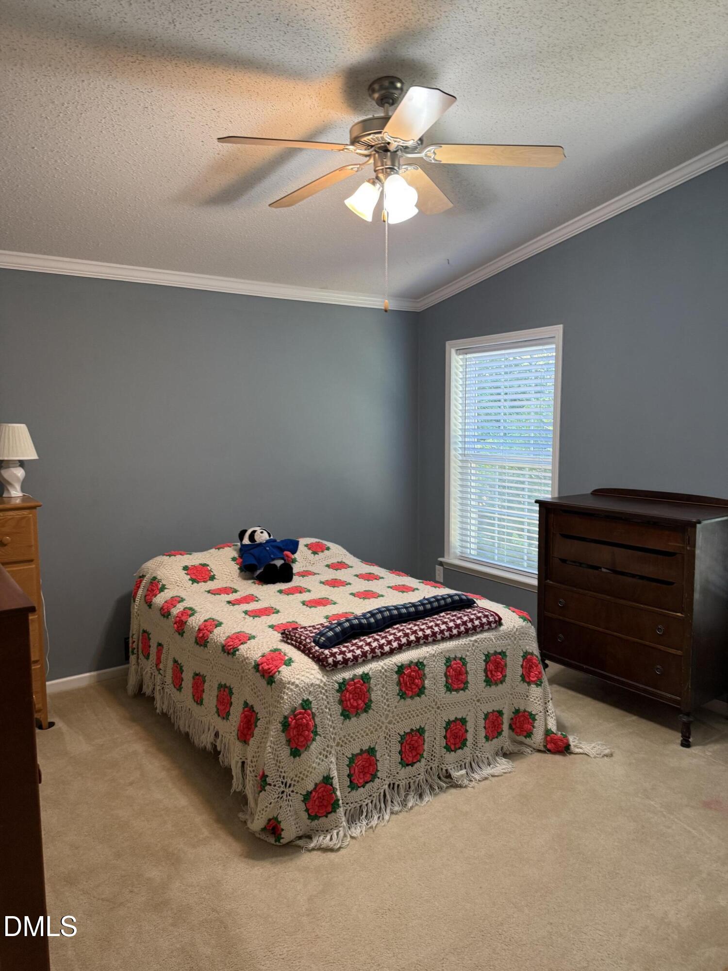 598 Ridge View Drive Cameron, NC 28326 - Photo 18 of 22 a bedroom with a bed and a chandelier