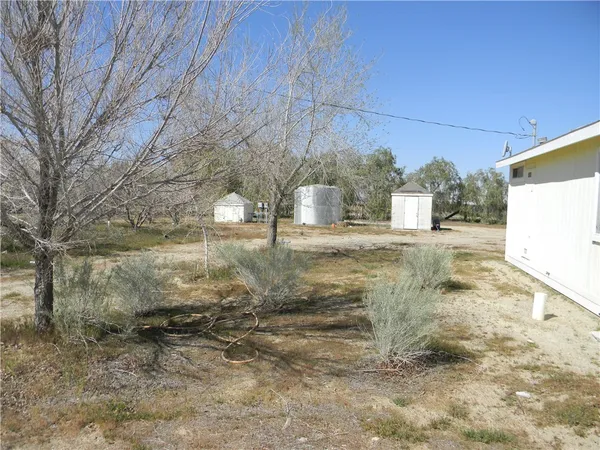 a view of a yard with wooden fence
