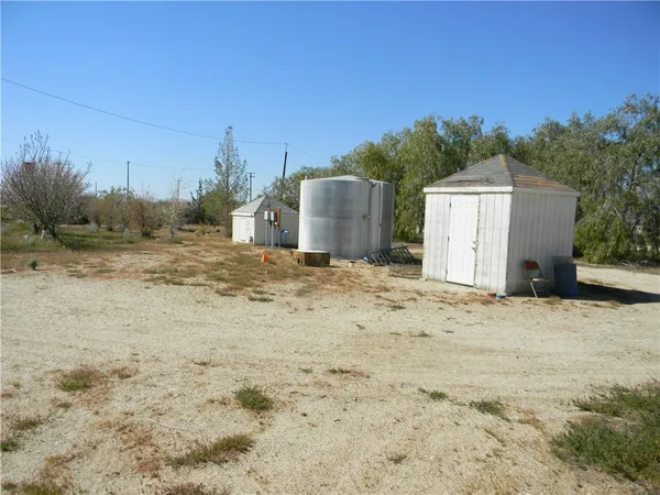 a view of a dry yard with a house