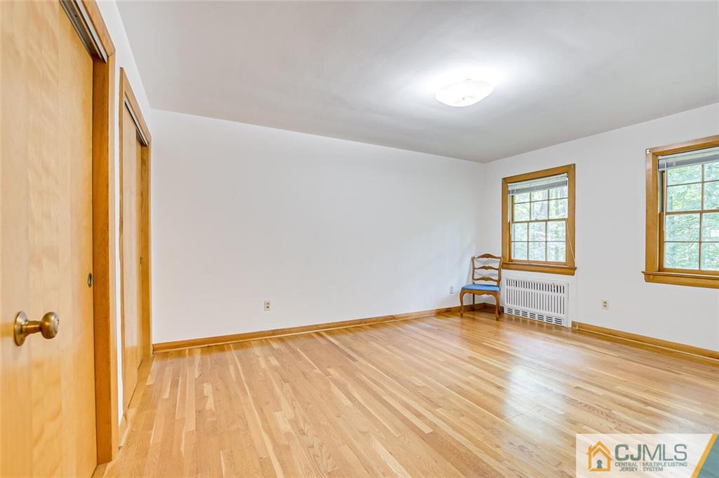 305 Ridge Road Watchung, NJ 07069 - Photo 12 of 41 an empty room with wooden floor and windows