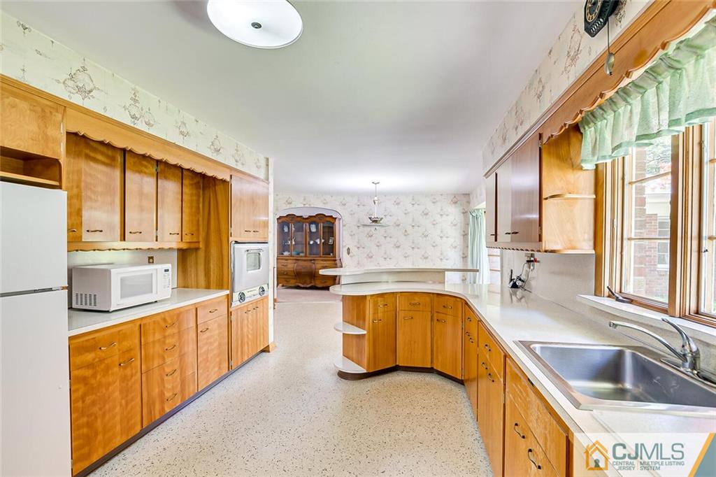 305 Ridge Road Watchung, NJ 07069 - Photo 23 of 41 a large kitchen with stainless steel appliances granite countertop a large window and a sink