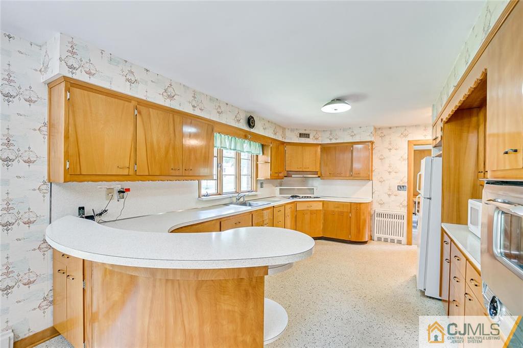 305 Ridge Road Watchung, NJ 07069 - Photo 24 of 41 a kitchen with stainless steel appliances granite countertop a sink and a refrigerator