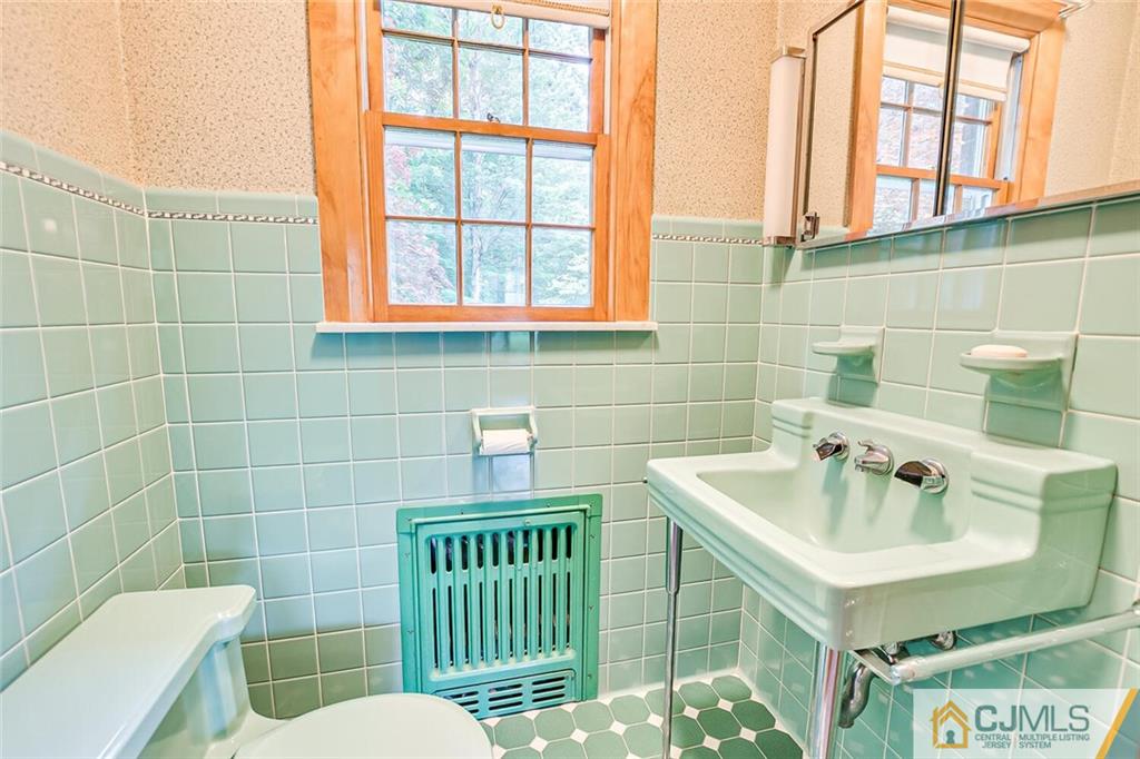 305 Ridge Road Watchung, NJ 07069 - Photo 25 of 41 a bathroom with a sink a toilet and a mirror