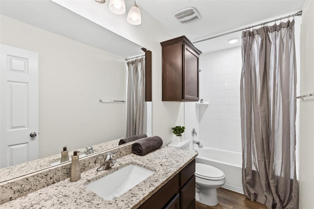 3105 Marston Road Lorena, TX 76655 - Photo 31 of 40 Bathroom vanity featuring a speckled countertop, integrated sink, and an expansive mirror