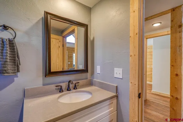 a bathroom with a sink vanity and a mirror