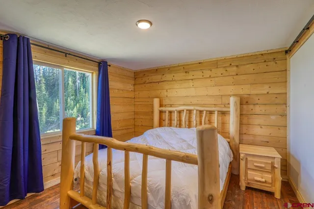 a view of a porch with wooden floor and furniture