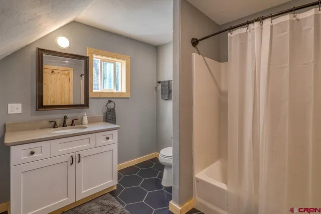 a bathroom with a sink a mirror and a shower