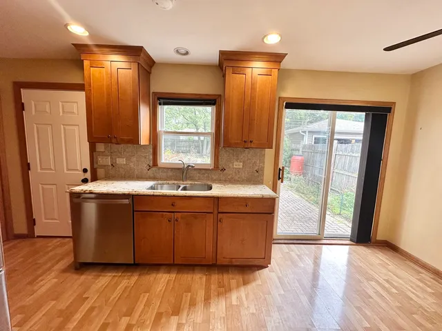 a large tub sitting in a en suite bathroom with a sink and mirror