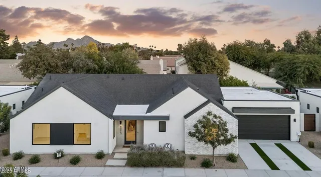 a aerial view of a house with a yard and garage