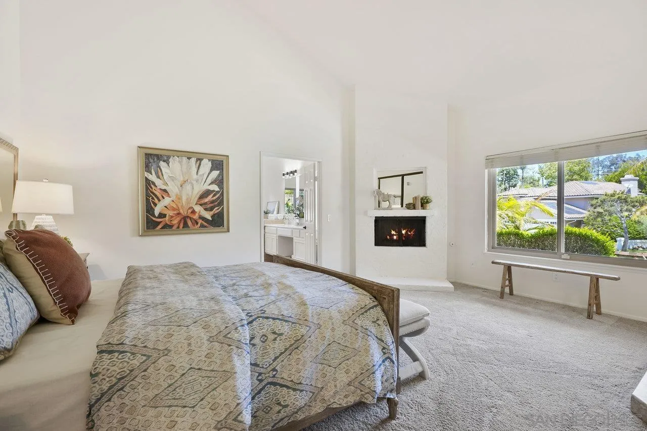 263 Via Villena Encinitas, CA 92024 - Photo 19 of 49 a spacious bedroom with a bed and a flat screen tv