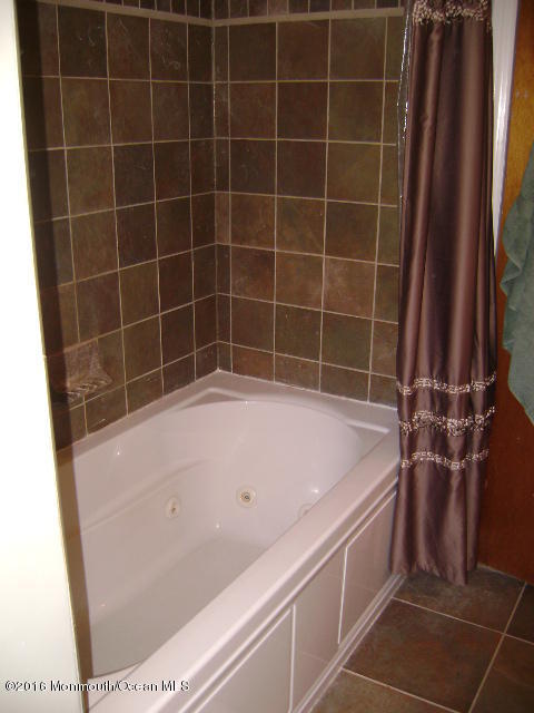 65 Skidmore Road Freehold, NJ 07728 - Photo 26 of 32 a bathroom with a bathtub