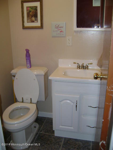65 Skidmore Road Freehold, NJ 07728 - Photo 27 of 32 a bathroom with a toilet sink and mirror