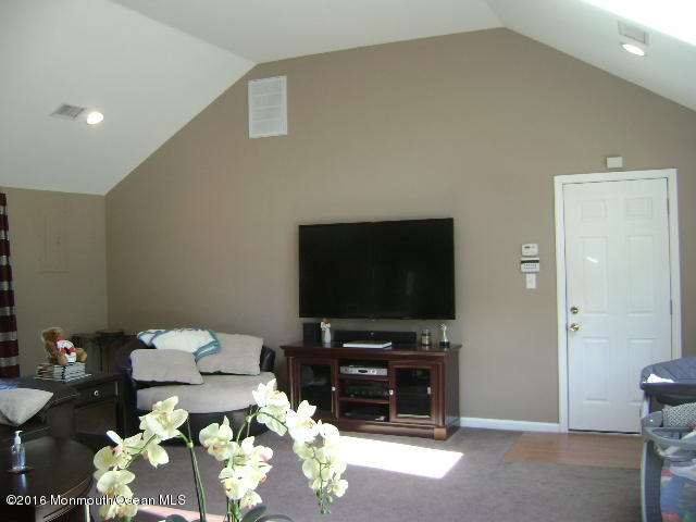 65 Skidmore Road Freehold, NJ 07728 - Photo 4 of 32 a living room with furniture and a flat screen tv