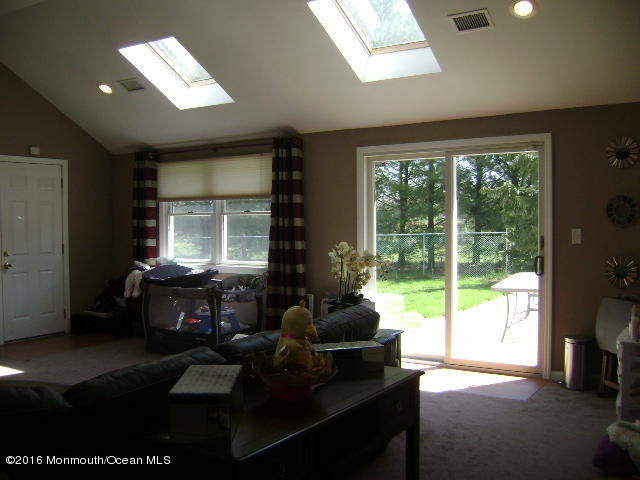 65 Skidmore Road Freehold, NJ 07728 - Photo 5 of 32 a living room with furniture and a large window