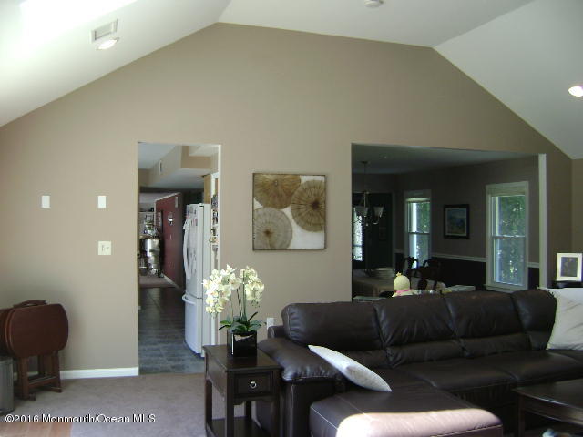 65 Skidmore Road Freehold, NJ 07728 - Photo 7 of 32 a living room with furniture and a potted plant