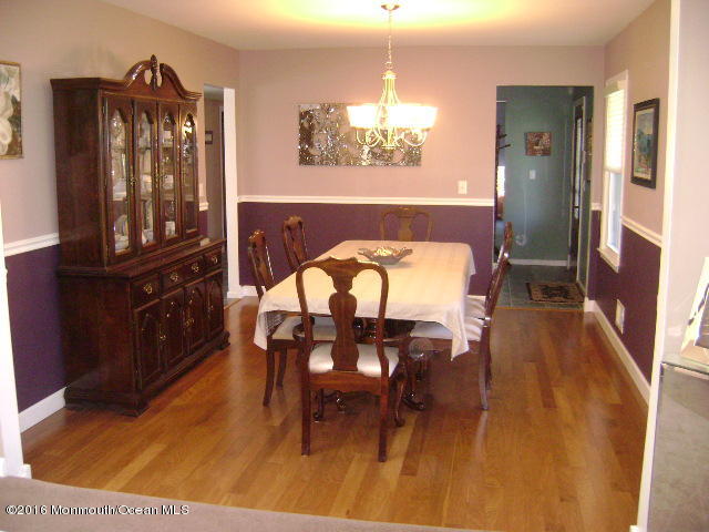 65 Skidmore Road Freehold, NJ 07728 - Photo 8 of 32 a dining room with furniture and chandelier