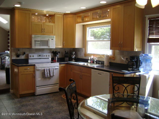 65 Skidmore Road Freehold, NJ 07728 - Photo 10 of 32 a kitchen with stainless steel appliances granite countertop a stove a sink and a refrigerator