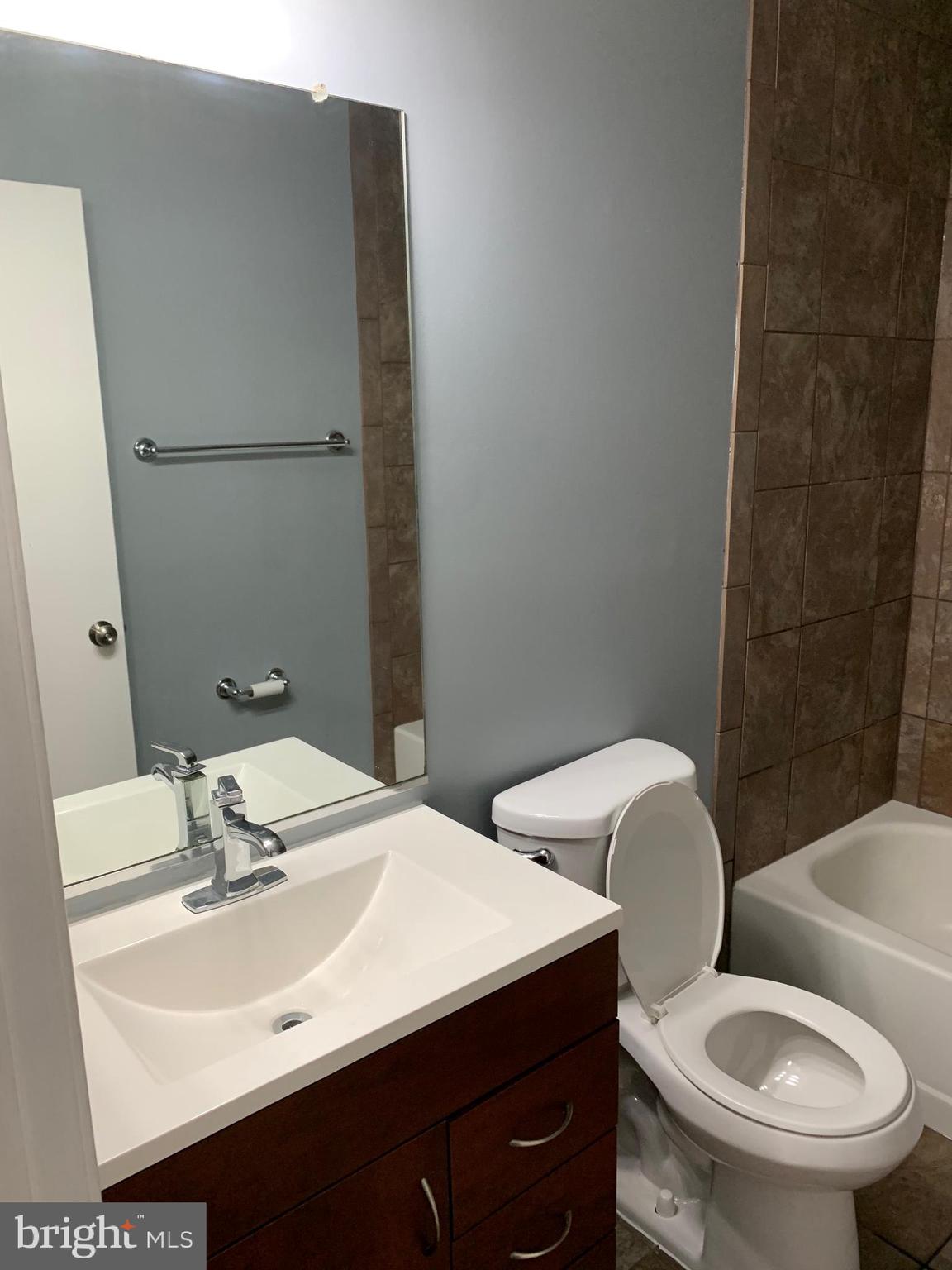 8555 Ritchboro Road District Heights, MD 20747 - Photo 13 of 30 a bathroom with a sink a toilet and mirror