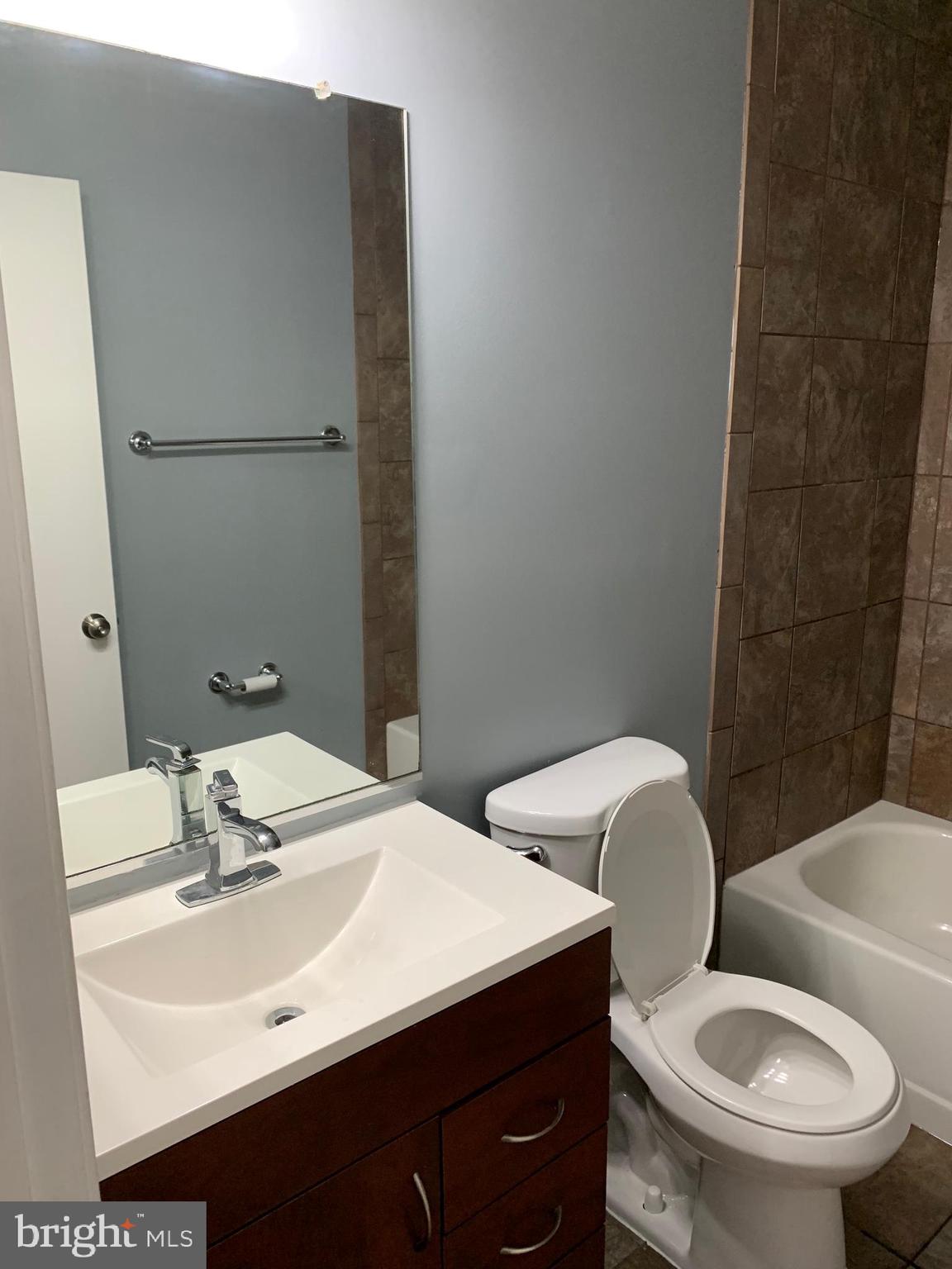 8555 Ritchboro Road District Heights, MD 20747 - Photo 14 of 30 a bathroom with a sink a toilet and mirror