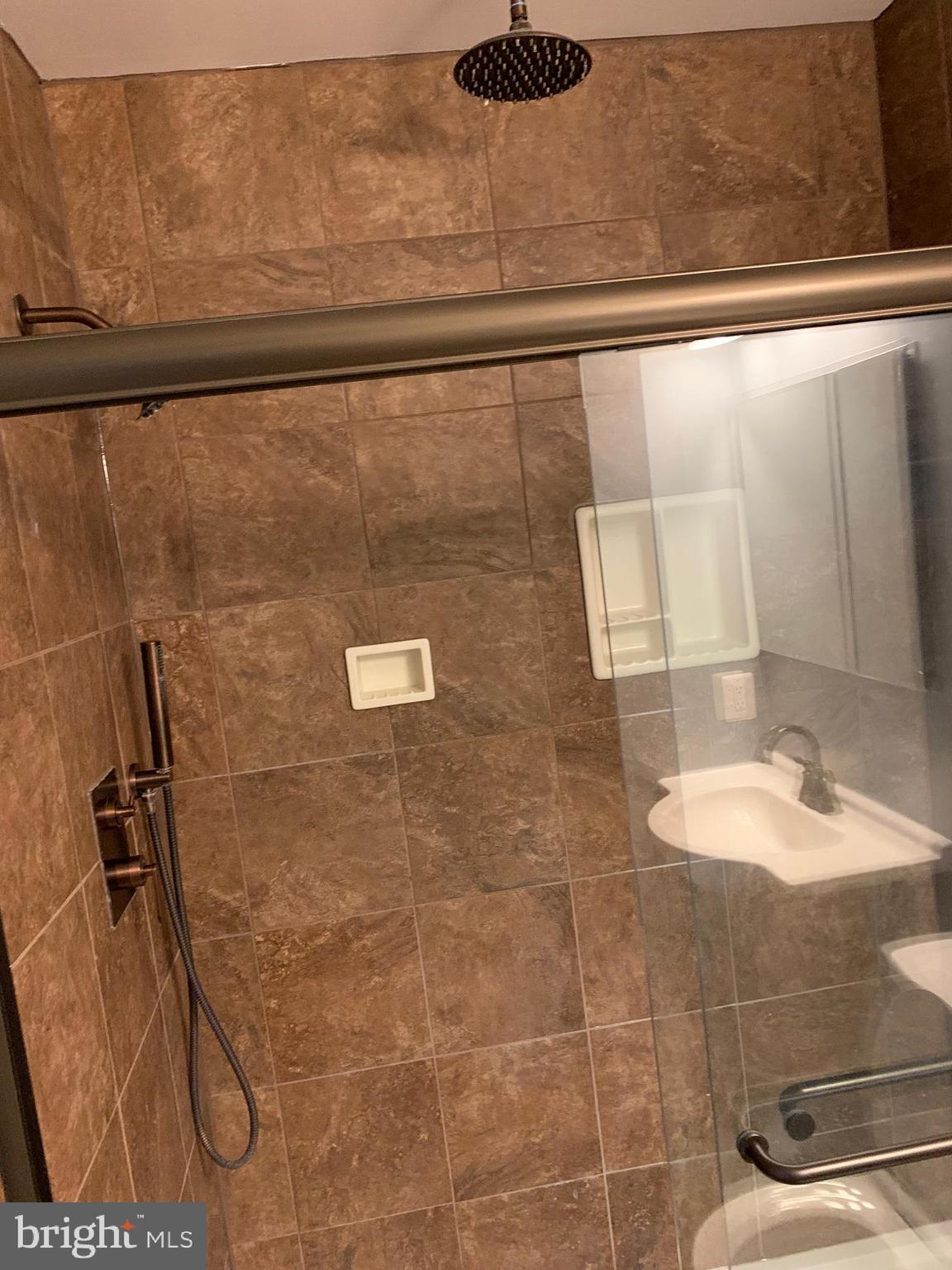8555 Ritchboro Road District Heights, MD 20747 - Photo 20 of 30 a bathroom with a granite countertop shower a sink and vanity