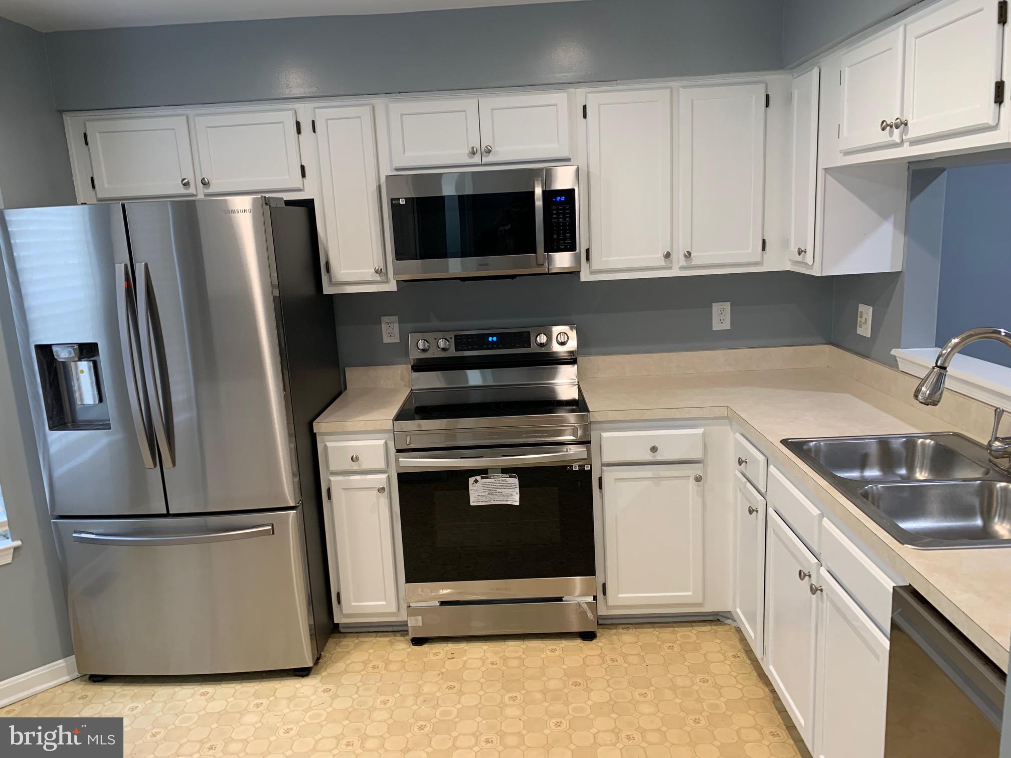 8555 Ritchboro Road District Heights, MD 20747 - Photo 6 of 30 a kitchen with a stove microwave and refrigerator
