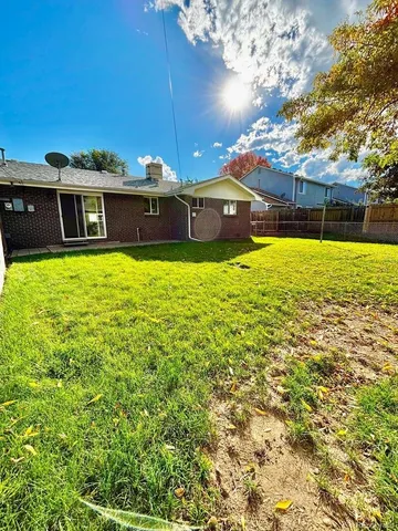 a view of yard with swimming pool and green space