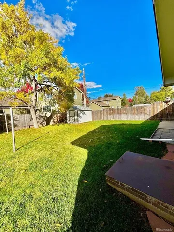 a view of a house with a backyard