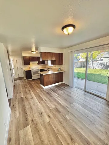 a kitchen with kitchen island stainless steel appliances a stove sink and cabinets