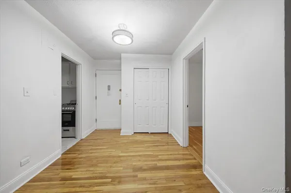 a view of a room with wooden floor
