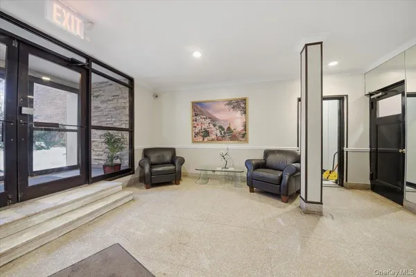 a living room with furniture and large windows