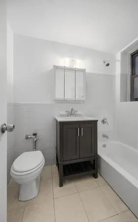 a bathroom with a sink a toilet and bathtub