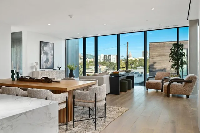 a large white kitchen with a large window and furniture