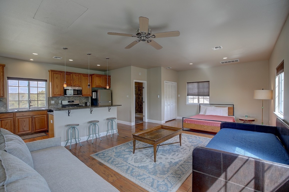 11228 Parsons Road Manor, TX 78653 - Photo 34 of 40 a living room with furniture and kitchen view