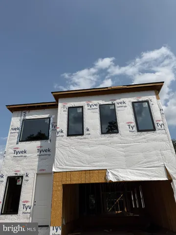 a view of kitchen with microwave stove and refrigerator