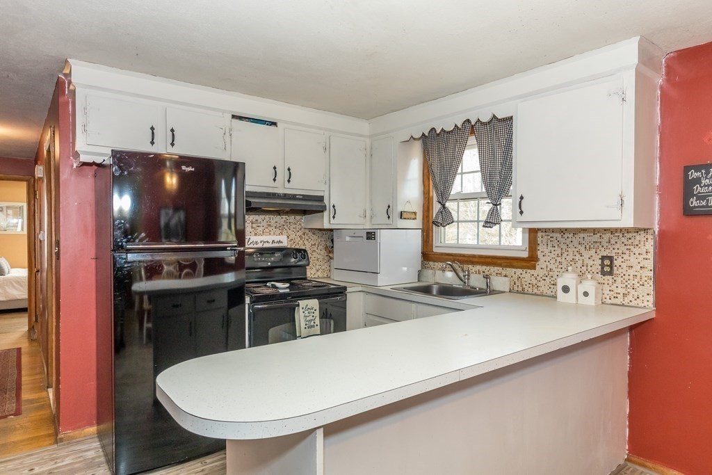 5 Harnden Road Billerica, MA 01821 - Photo 8 of 17 a kitchen with a sink stainless steel appliances and white cabinets