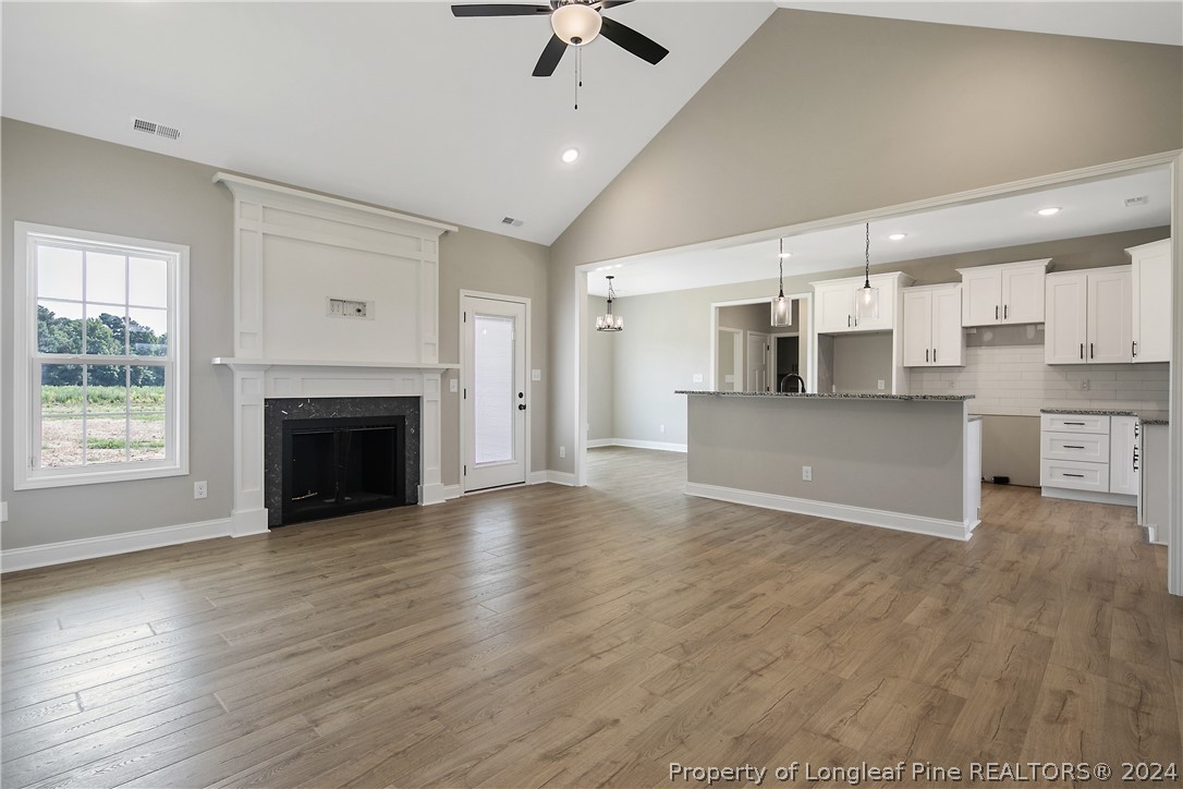 175 Spring Branch Road Tar Heel, NC 28392 - Photo 13 of 50 a view of a kitchen with a stove cabinets and wooden floor