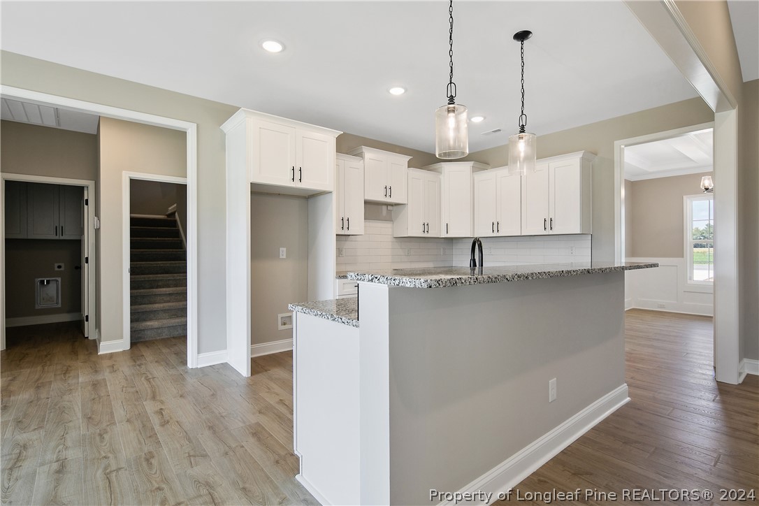 175 Spring Branch Road Tar Heel, NC 28392 - Photo 17 of 50 a view of a kitchen with stainless steel appliances granite countertop a refrigerator a sink and wooden floor