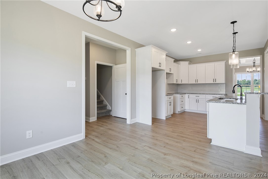 175 Spring Branch Road Tar Heel, NC 28392 - Photo 19 of 50 a view of kitchen with wooden floor and window
