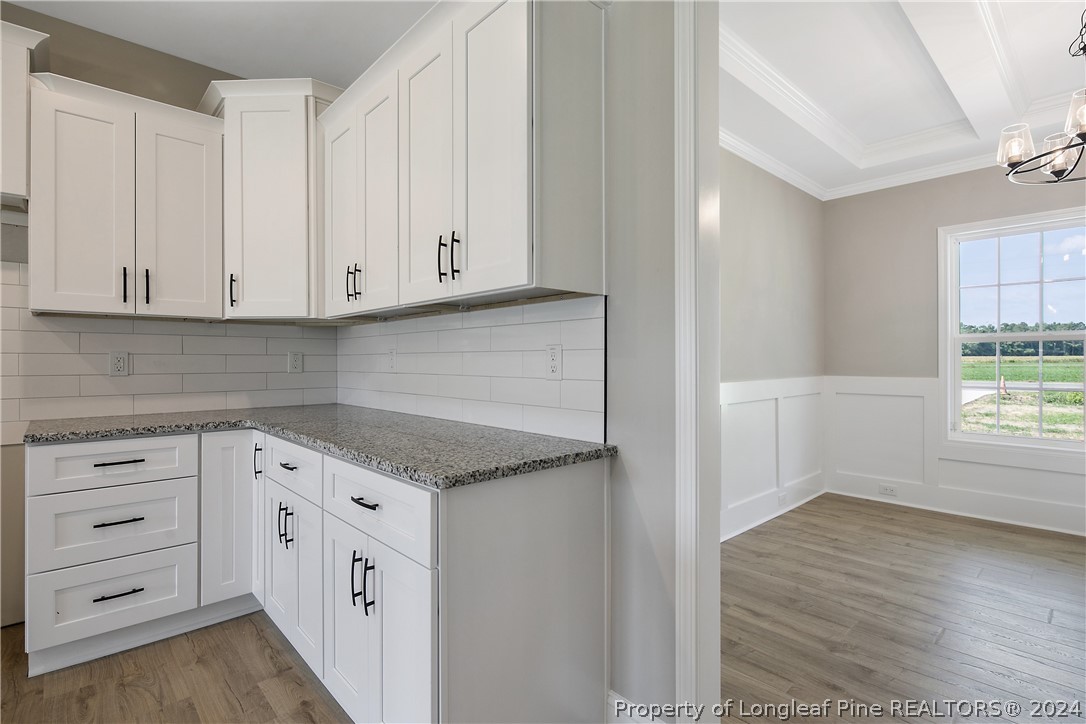 175 Spring Branch Road Tar Heel, NC 28392 - Photo 24 of 50 a kitchen with granite countertop white cabinets and sink