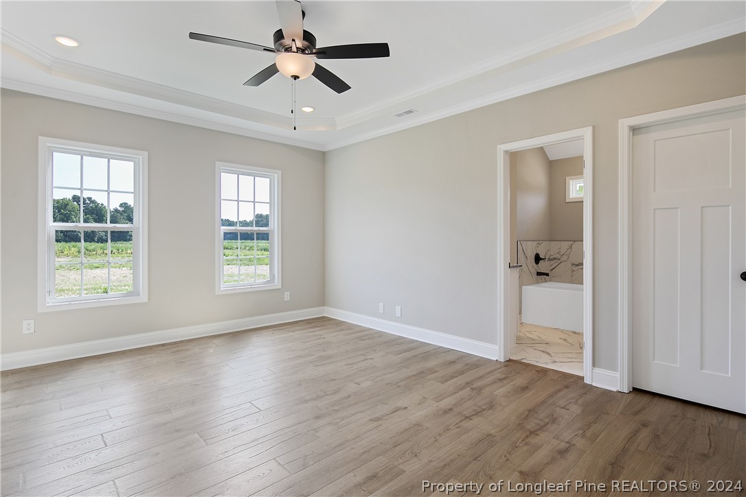 175 Spring Branch Road Tar Heel, NC 28392 - Photo 27 of 50 a view of empty room with wooden floor and fan
