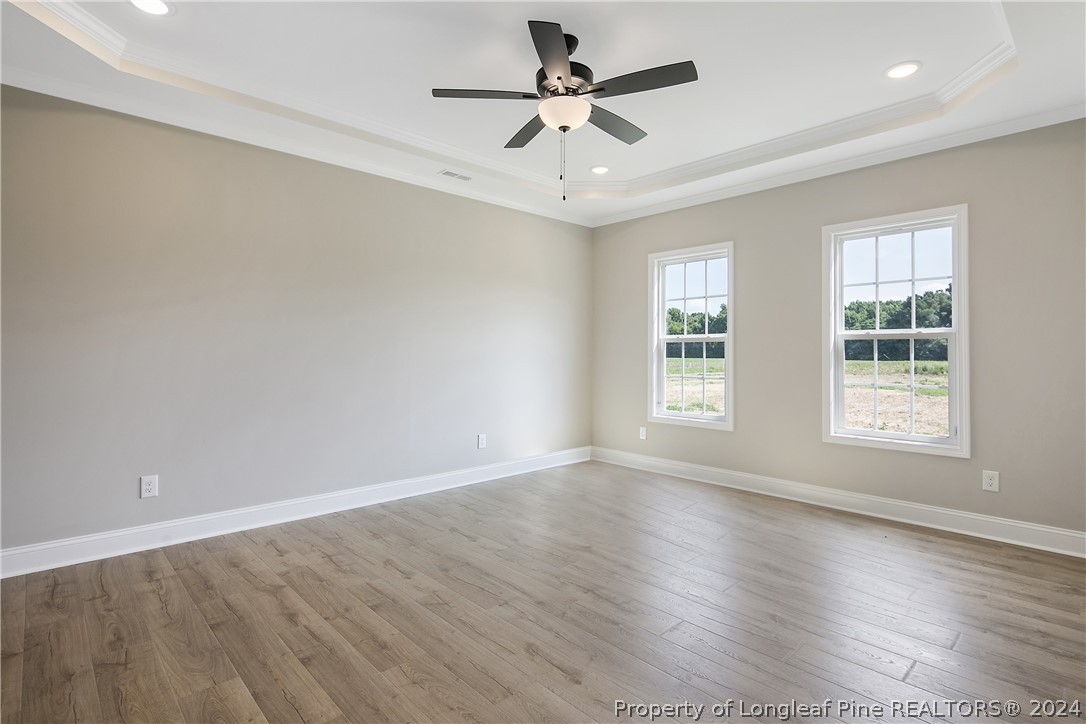 175 Spring Branch Road Tar Heel, NC 28392 - Photo 30 of 50 wooden floor in an empty room with a window