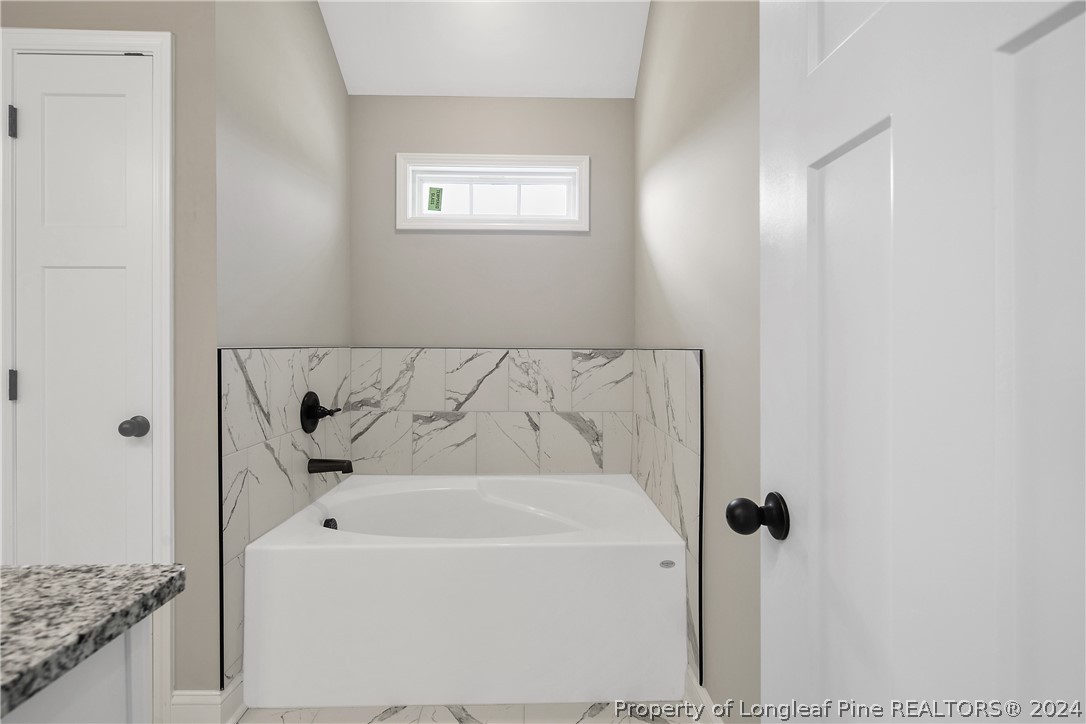 175 Spring Branch Road Tar Heel, NC 28392 - Photo 33 of 50 a bathroom with a bathtub and shower