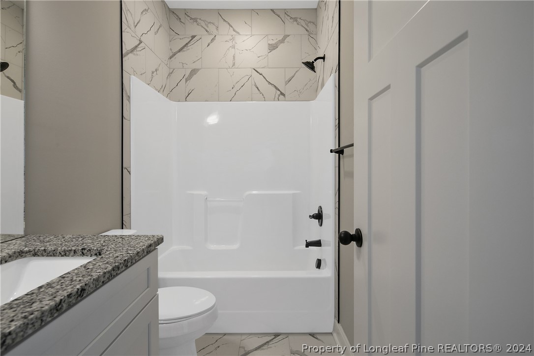 175 Spring Branch Road Tar Heel, NC 28392 - Photo 41 of 50 a bathroom with a granite countertop sink a toilet and bathtub