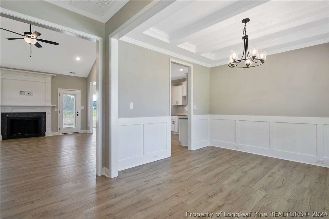 175 Spring Branch Road Tar Heel, NC 28392 - Photo 7 of 50 a view of a room with wooden floor ceiling fan and window
