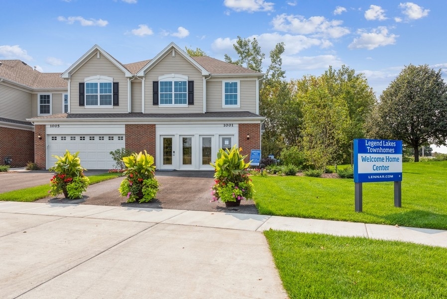 1327 Draper Road McHenry, IL 60050 - Photo 1 of 10 a front view of a house with a garden and plants