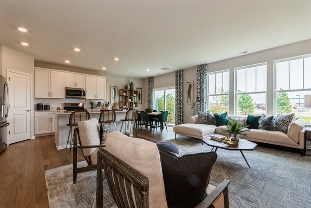 1327 Draper Road McHenry, IL 60050 - Photo 5 of 10 a living room with fireplace furniture and a large window