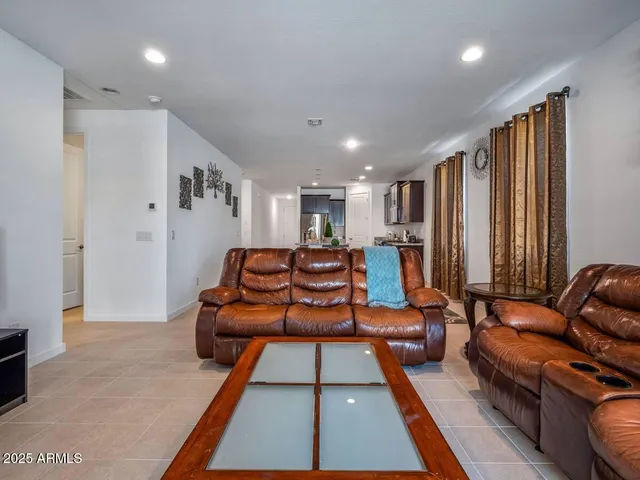 a living room with furniture a rug and a large window