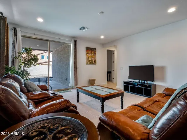 a bedroom with furniture and a flat screen tv